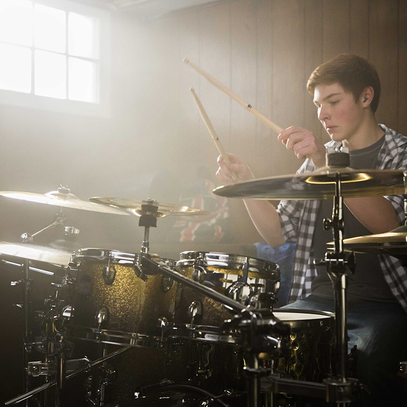 A boy playing the drums.